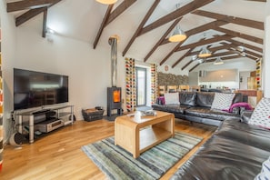 Hunter's Barn, St Agnes. Large open living space kept warm by the wood burning stove
