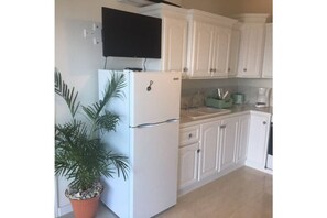 Ample cupboards to keep things organized in this petite kitchen. 