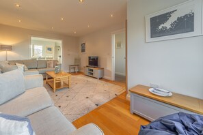 Sea Folly, Perranporth. First floor: Sitting room with a television, double sofa bed and views across the village and out to sea