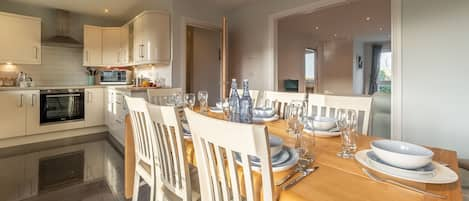 Sea Folly, Perranporth. First floor: Dining room with table and seating for ten and doors to balcony