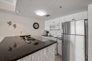 An updated kitchen with granite counter tops makes meal prep a breeze.