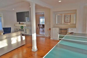 The large living room also includes a sofa and wall-mounted tv.