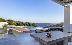 Lounge area by the pool with sea view