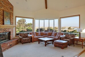 The living room offers a wall of windows featuring the view