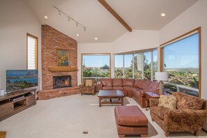 Living room with fireplace, flatscreen tv, and ample comfortable seating