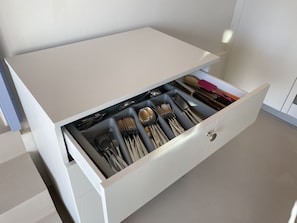 Drawer with set of forks, knives and spoons for 12 people