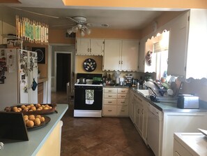 Large kitchen with window and door to back yard.