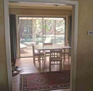 Looking through dining room to large screened porch.