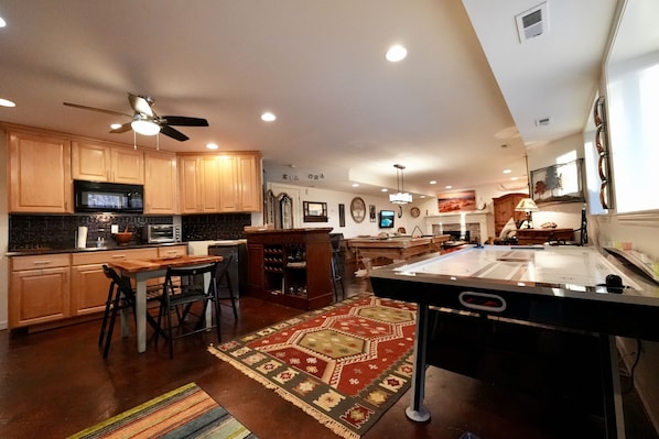 Large comfortable living space with air hockey, pool & toasty fireplace