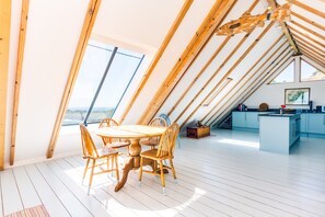 Dolphins, Coverack. First floor: Open-plan living area with dining table and seating for six
