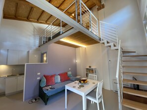 The main room with a sofa bed and dining table