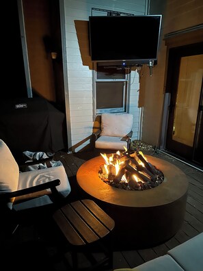Beautiful back deck with fire pit, outdoor TV, BBQ and year-round furniture.