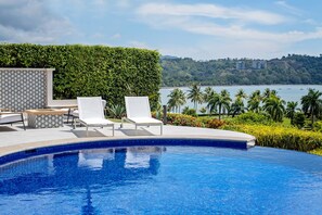 The villa's pool area provides a private sanctuary for relaxation, with plush sunbeds and a shaded lounge space. Enjoy the tranquility of your own oasis as the pool's infinity edge appears to merge seamlessly with the vastness of the Pacific Ocean.