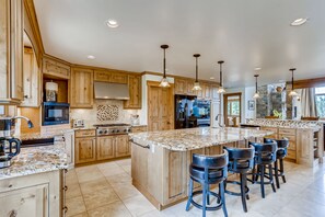 Large chefs kitchen with seating for 4 at breakfast bar