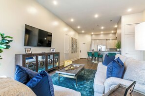 Open concept living, kitchen, and dining area with comfortable seating options for you and your guests. 65” Samsung Smart 4K TV for streaming apps and DIRECTV Entertainment. Pub-style dining table with seating for three. All the natural light too!