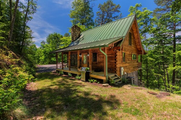 This newly built log cabin is a modern take on a classic Appalachian mountain cabin architectural design, with hand built stacked stone fireplace and rough planed log walls.