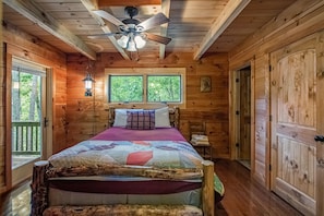 The rustic decor continues into the master bedroom which has a queen size bed and satellite TV.