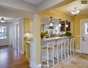 View of front entrance (left), kitchen (center) & mudroom (right) from family rm