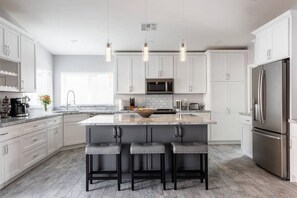 Clean and modern kitchen complete with a sit up bar/kitchen island.