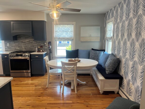 Eat in kitchen with new LG stove and sunbrella pillows