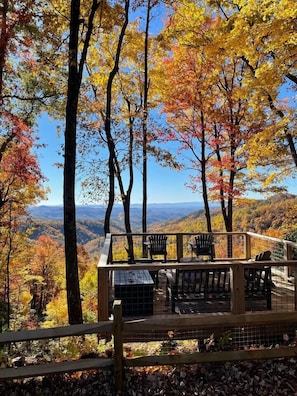 Fall view from the viewing deck with teak furniture and fire pit