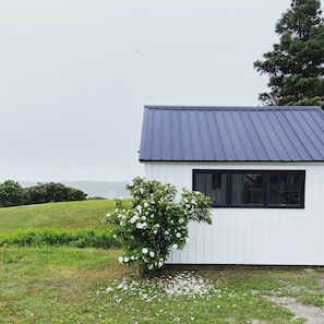 shed with ocean view desk and outdoor dining supplies