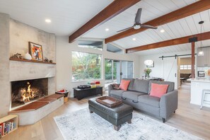 Cozy up by the fire in this stylishly appointed living area, where comfort and contemporary design blend to create a warm, welcoming space.