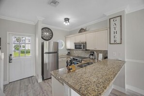 Front door next to kitchen