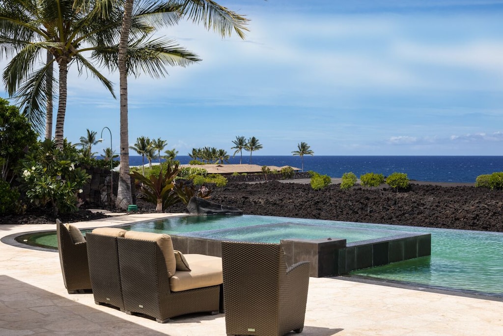 Terrace overlooking pool and black sand beaches Hawaii Big Island