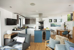 The Deck House, St Agnes: Open-plan living space with kitchen, dining and sitting areas