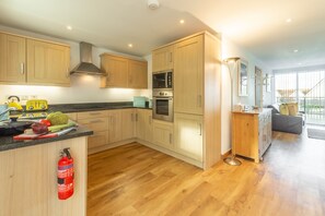 Headland Beaches, Newquay. Upper ground floor: Open plan kitchen with oven, hob, microwave, fridge, freezer, dishwasher and washer dryer