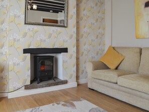 Cosy and warm living room with electric wood burner | Squirrel Cottage, Seamer, near Scarborough