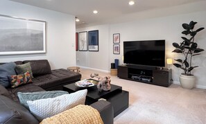Spacious leather sectional with 60" 4K tv, surround sound system and free cable