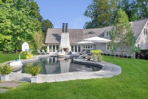 Poolside entertaining barn with full outdoor amenities including speakers