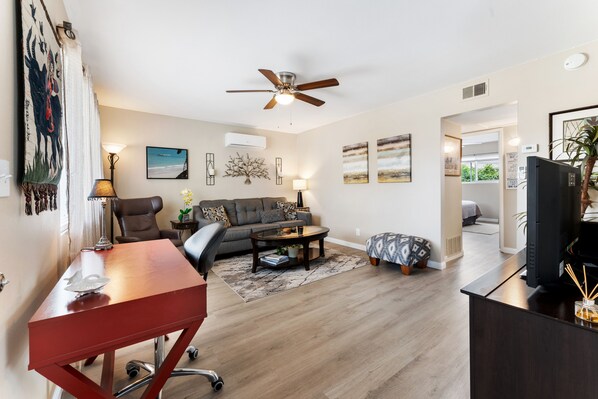  Living room has computer desk for working remotely