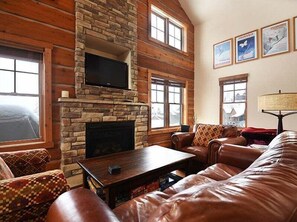 StayWinterPark 25 Discovery Lane Rendezvous gas fireplace and TV in living area
