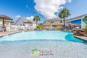 The smaller pool with lagune style entry is located in front of the patio