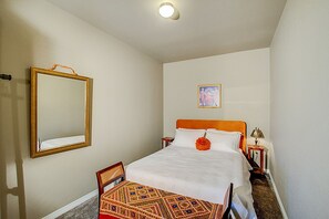 Second bedroom is comfortable and cozy.  Features dresser drawers & clothes rack