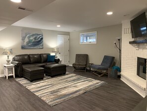 Inviting living room with pull out sofa bed, Smart TV, and electric fireplace