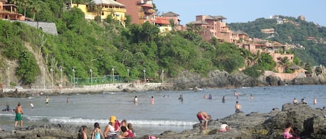 View of beach with homes on the hills