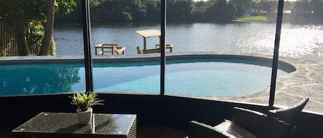Screened in patio overlooking pool and lake