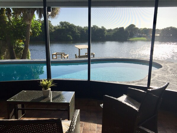 Screened in patio overlooking pool and lake