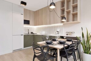 Kitchenette with plenty of kitchen utensils and dishes. 