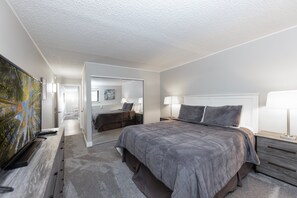 Master bedroom with queen bed, smart TV and private bathroom.