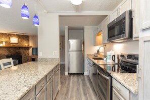 Full kitchen with stainless steel appliances.