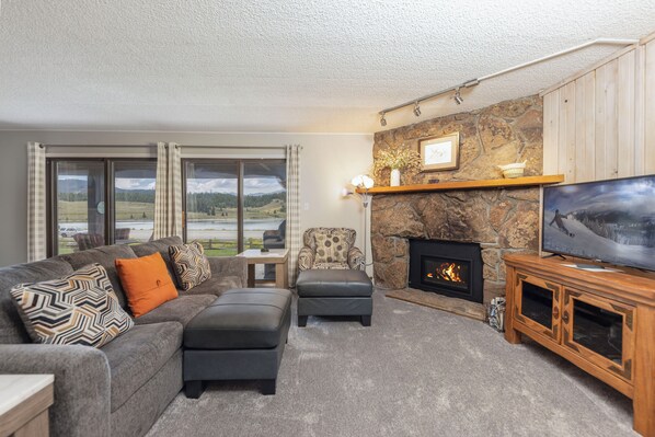 Spacious living area with gas fireplace and smart TV.