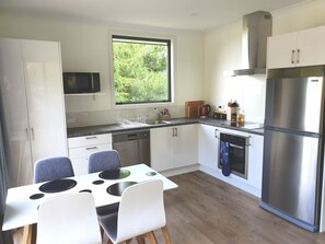 Full sized kitchen with dishwasher, microwave, hob and oven.