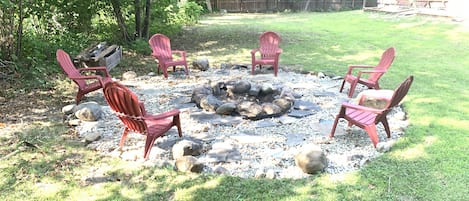 Fire pit and .66 acre lot extends on both sides of house