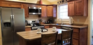 Well equipped kitchen with new appliances and breakfast bar.