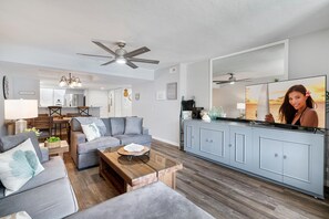 Living Area with TV, Sectional Sofa, Breakfast Bar, and Ceiling Fan